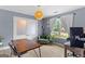 A well-lit home office with modern decor, hardwood floors, and double glass doors at 344 Mckibben Dr, Locust Grove, GA 30248