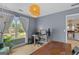 Bright home office space with a wooden desk, stylish decor, and natural light at 344 Mckibben Dr, Locust Grove, GA 30248