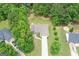 Aerial view of home on a spacious lot, surrounded by lush greenery and mature trees at 320 Cobb Ct, Hampton, GA 30228