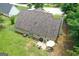 Aerial view of backyard with a patio set, grill, lush lawn, and mature trees at 320 Cobb Ct, Hampton, GA 30228