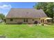 Expansive backyard with a well-maintained lawn, patio seating, and a barbecue grill for outdoor gatherings at 320 Cobb Ct, Hampton, GA 30228