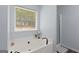Bathroom showcasing a modern soaking tub with matte black fixtures and soft, natural lighting at 320 Cobb Ct, Hampton, GA 30228
