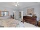 Large bedroom with an ornate dresser and a bed with floral patterned blanket and pillows at 320 Cobb Ct, Hampton, GA 30228