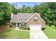 Charming two-story home featuring a stone facade, well-manicured lawn, and an attached two-car garage at 320 Cobb Ct, Hampton, GA 30228