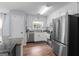 Functional kitchen with stainless steel appliances, white cabinets, and plenty of counter space at 320 Cobb Ct, Hampton, GA 30228