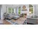 Comfortable living room featuring a fireplace, large windows with natural light, and stylish decor at 320 Cobb Ct, Hampton, GA 30228