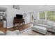 Cozy living room with vaulted ceilings, a comfortable couch, and a large window at 320 Cobb Ct, Hampton, GA 30228