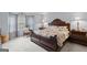 Spacious main bedroom with a large bed, wood furniture, and decorative pillows at 320 Cobb Ct, Hampton, GA 30228
