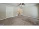 The spacious bedroom features a ceiling fan, carpet flooring, and a double-door closet for storage at 2047 Gazebo Ln, Snellville, GA 30078
