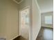 Bedroom view into the main bathroom, with hardwood floors and a ceiling fan at 2047 Gazebo Ln, Snellville, GA 30078