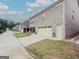 View of a new construction home with brick exterior, garage, and a well-maintained lawn at 2047 Gazebo Ln, Snellville, GA 30078