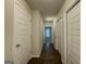 The hallway features wood floors and white doors, creating a simple and modern design element at 2047 Gazebo Ln, Snellville, GA 30078