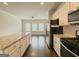 Contemporary kitchen features granite countertops, stainless steel appliances, hardwood floors, and an open layout at 2047 Gazebo Ln, Snellville, GA 30078