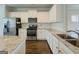 Bright, modern kitchen with white cabinetry, granite counters, and stainless steel appliances at 2047 Gazebo Ln, Snellville, GA 30078