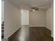 An open living room featuring hardwood floors and a ceiling fan, creating a warm and inviting space at 2047 Gazebo Ln, Snellville, GA 30078