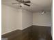 The spacious living room has hardwood floors, two ceiling fans, and natural light to provide ample room at 2047 Gazebo Ln, Snellville, GA 30078
