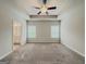 Spacious main bedroom with ensuite bathroom access, large windows, and ceiling fan at 2047 Gazebo Ln, Snellville, GA 30078