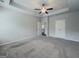 Expansive main bedroom featuring a tray ceiling, fan, and double doors to the ensuite bathroom and walk-in closet at 2047 Gazebo Ln, Snellville, GA 30078