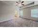 Bright main bedroom with ceiling fan, two windows, and ensuite bathroom entrance at 2047 Gazebo Ln, Snellville, GA 30078