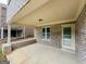 A covered brick patio with a concrete floor and door to the backyard that is perfect for outdoor enjoyment at 2047 Gazebo Ln, Snellville, GA 30078