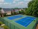 Community tennis courts are well-maintained, nestled among mature trees and manicured landscaping at 2047 Gazebo Ln, Snellville, GA 30078