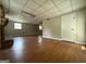 Large basement area with wood-look floors, windows, a fireplace and a door at 1486 Harbour Oaks Rd, Tucker, GA 30084