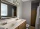 Bathroom features a double sink vanity, a mirror, a window and a shower with a curtain at 1486 Harbour Oaks Rd, Tucker, GA 30084