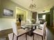 Dining room with modern table set, stylish decor, and view to an open living space at 1486 Harbour Oaks Rd, Tucker, GA 30084