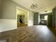 Open dining area with hardwood floors, modern lighting, and view into living room at 1486 Harbour Oaks Rd, Tucker, GA 30084