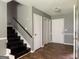 Hallway with hardwood floors, staircase, and multiple entryways with neutral wall paint at 1486 Harbour Oaks Rd, Tucker, GA 30084
