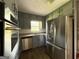 Kitchen showcasing stainless steel appliances, stone countertops, and soft blue cabinets at 1486 Harbour Oaks Rd, Tucker, GA 30084