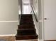 A staircase with wooden stairs and a white wall at 1486 Harbour Oaks Rd, Tucker, GA 30084