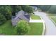 Aerial view of a home in a neighborhood with a well-manicured lawn and mature trees at 185 Stewart Glen Dr, Covington, GA 30014
