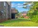 Exterior view of a multi-story house with a wooden deck overlooking a green lawn at 185 Stewart Glen Dr, Covington, GA 30014