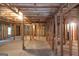 An unfinished basement with exposed wooden framing and a concrete slab floor at 185 Stewart Glen Dr, Covington, GA 30014