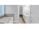 A bright bathroom shows a garden tub and white vanity at 185 Stewart Glen Dr, Covington, GA 30014