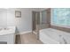 Bright bathroom features separate shower and tub plus tile floors at 185 Stewart Glen Dr, Covington, GA 30014
