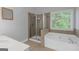 Bathroom with separate shower and tub with natural light at 185 Stewart Glen Dr, Covington, GA 30014
