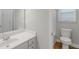 Bright bathroom features toilet, tile floors, vanity, and mirror at 185 Stewart Glen Dr, Covington, GA 30014