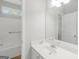 Bright bathroom features tub with shower, tile floors, vanity, and mirror at 185 Stewart Glen Dr, Covington, GA 30014