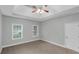 Cozy bedroom features neutral walls, carpet, and ample natural light at 185 Stewart Glen Dr, Covington, GA 30014
