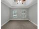 Spacious bedroom with neutral walls, carpet, two windows and ceiling fan at 185 Stewart Glen Dr, Covington, GA 30014