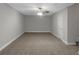 A bedroom featuring neutral walls, a lighted ceiling fan, and white trim at 185 Stewart Glen Dr, Covington, GA 30014