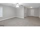 A spacious bedroom offering neutral colored walls, white trim, and a lighted ceiling fan at 185 Stewart Glen Dr, Covington, GA 30014