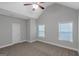 Bright bedroom features neutral walls, carpet, two windows, and a closet at 185 Stewart Glen Dr, Covington, GA 30014