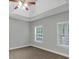 A sunlit bedroom offers neutral walls, carpet, and two windows at 185 Stewart Glen Dr, Covington, GA 30014