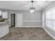 Dining room with modern light fixture, wainscoting, neutral paint, and durable flooring at 185 Stewart Glen Dr, Covington, GA 30014