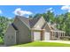 Side view of a brick home with a two-car garage, complemented by a green lawn and trees at 185 Stewart Glen Dr, Covington, GA 30014