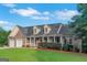 Inviting two-story home with a covered porch, well maintained lawn, and brick veneer at 185 Stewart Glen Dr, Covington, GA 30014