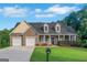 Charming brick home with a two-car garage, long porch, and well-manicured lawn at 185 Stewart Glen Dr, Covington, GA 30014